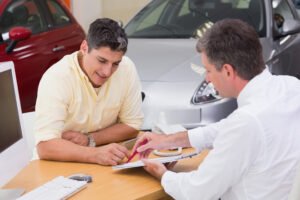 Handshake over car keys, symbolizing a successful Auto Title Loan partnership with TFCILOAN. Empower yourself with our guide to Auto Title Loans in Birmingham, Alabama."