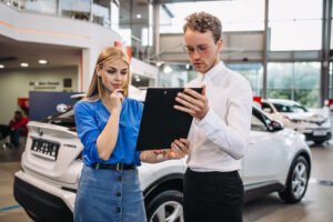 Handshake over car keys, symbolizing trust and reliability in Auto Title Loans in Hoover, Alabama. Our guide provides the essential insights for making secure financial decisions."